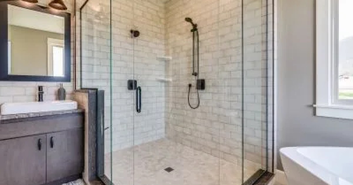 Installed shower with wall panels, fixtures, and a glass enclosure