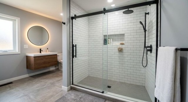 Converted tub area with a walk-in shower base, wall surround, and practical fixtures