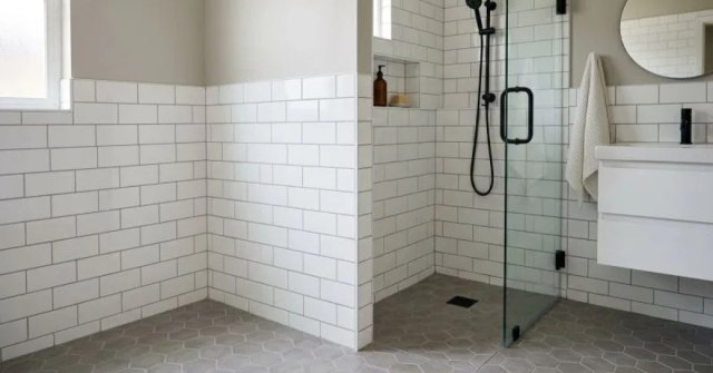 Patterned bathroom floor tile beside a tiled shower wall